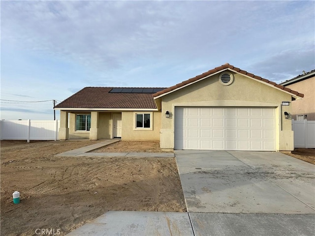 view of front facade featuring a garage and solar panels