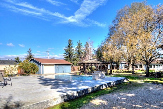 view of swimming pool featuring a gazebo, a patio, and an outdoor structure