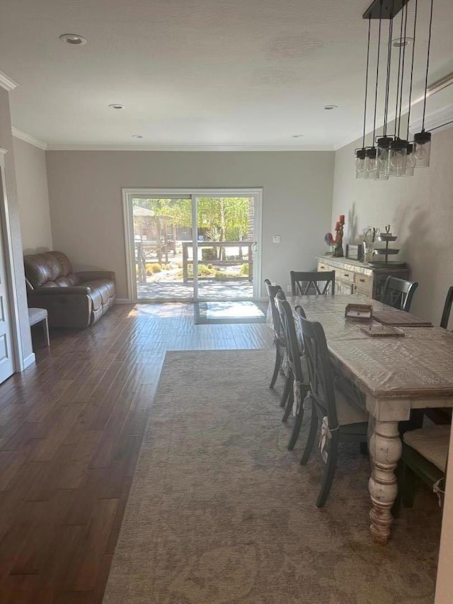 dining room with dark hardwood / wood-style flooring and ornamental molding