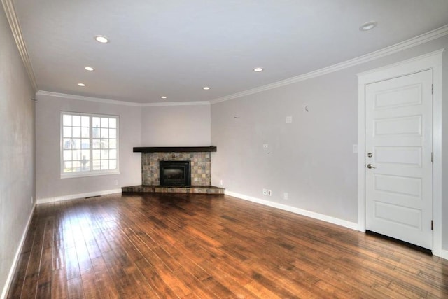 unfurnished living room with a stone fireplace, ornamental molding, and hardwood / wood-style floors