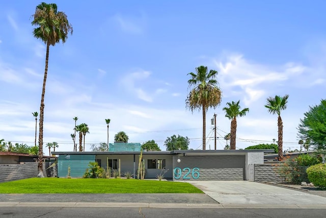 ranch-style house with a garage and a front yard