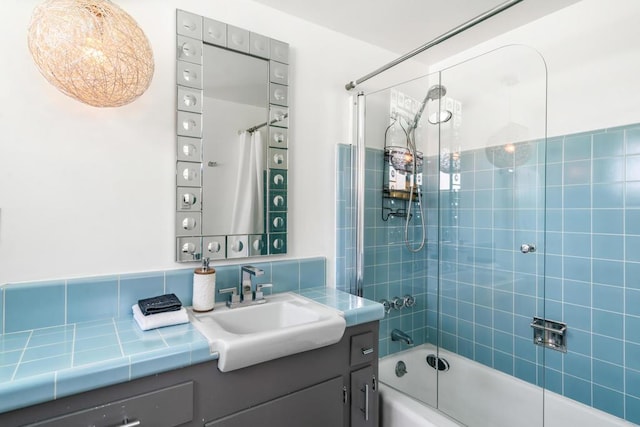 bathroom with vanity and tiled shower / bath combo