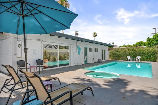 view of pool featuring an in ground hot tub and a patio