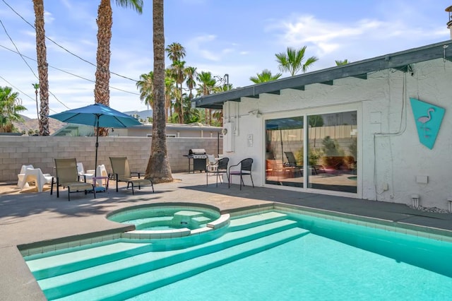 view of pool featuring grilling area, an in ground hot tub, and a patio