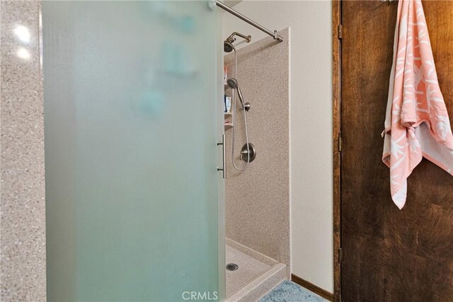 bathroom with tiled shower