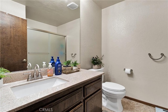 bathroom with toilet, vanity, tile patterned flooring, and an enclosed shower