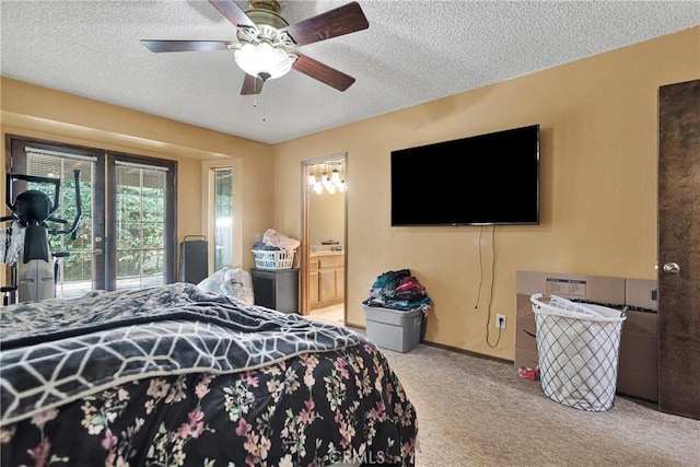 bedroom with ceiling fan, ensuite bath, access to exterior, a textured ceiling, and carpet flooring