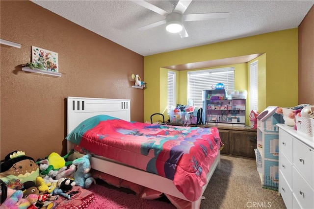 carpeted bedroom with a textured ceiling and ceiling fan