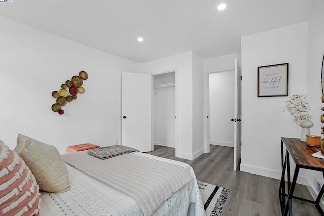 bedroom with dark hardwood / wood-style flooring and a closet