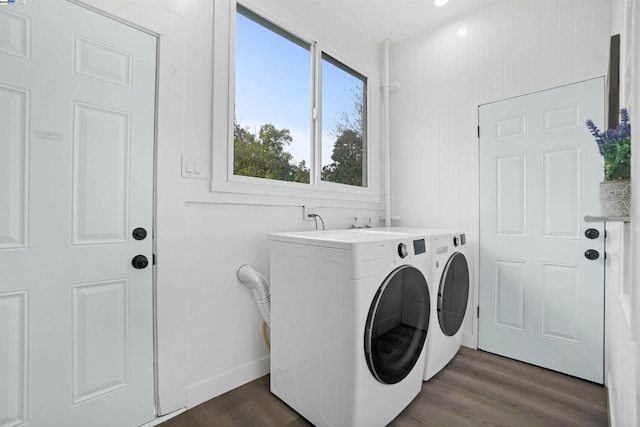 laundry room featuring dark hardwood / wood-style flooring and washing machine and clothes dryer