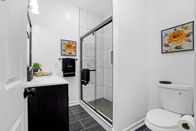 bathroom featuring walk in shower, vanity, and toilet