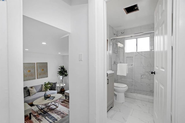 bathroom featuring vanity, an enclosed shower, and toilet