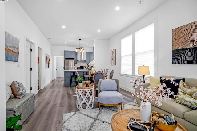 living room with a chandelier and hardwood / wood-style flooring