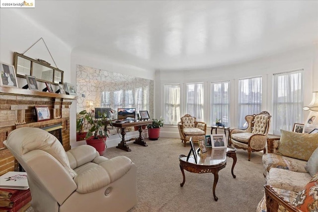 living room with light colored carpet and a fireplace