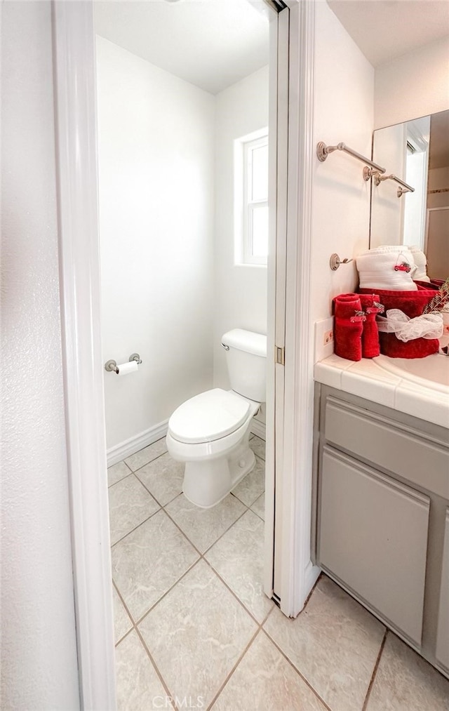 bathroom with tile patterned flooring and toilet