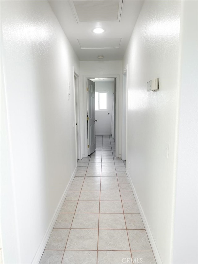 corridor with light tile patterned floors