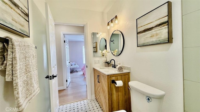 bathroom featuring toilet and vanity