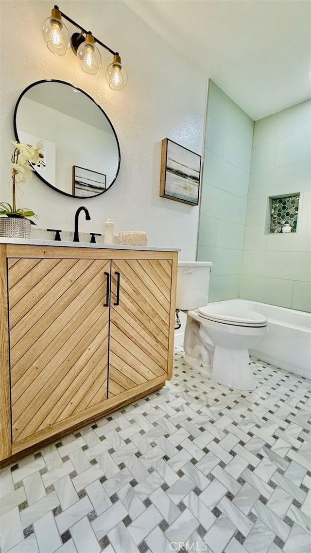 full bathroom featuring toilet, vanity, and washtub / shower combination