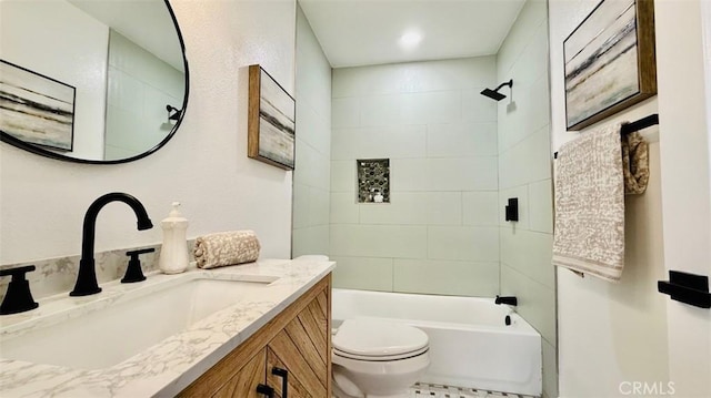 full bathroom featuring toilet, vanity, and tiled shower / bath