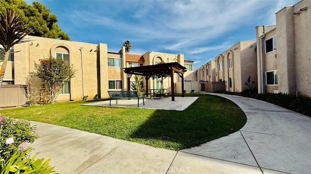 view of property's community with a pergola and a lawn