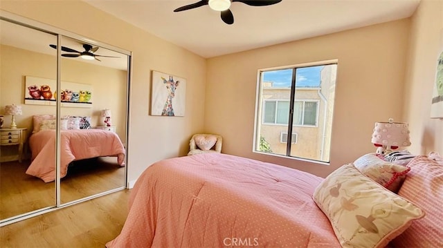 bedroom featuring ceiling fan, a closet, and hardwood / wood-style floors