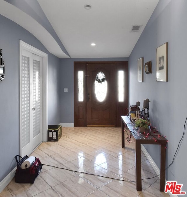 entryway featuring lofted ceiling