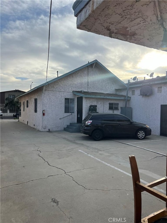 1021 E 12th St, Long Beach, CA 90813 - view of side of home with stucco siding and entry steps
