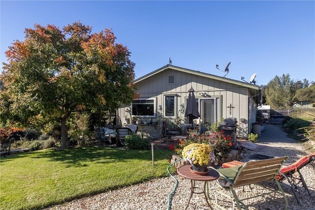 rear view of house with a yard