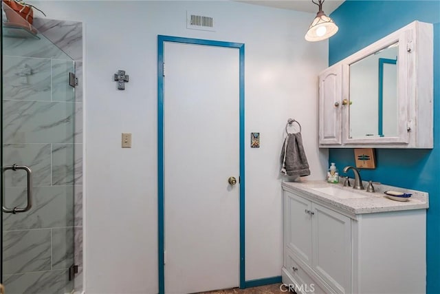 bathroom featuring walk in shower and vanity