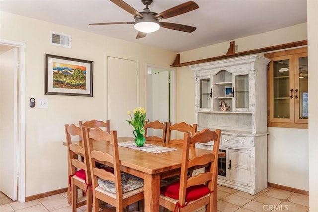 dining area featuring ceiling fan and light tile patterned floors