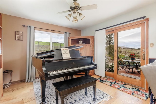 misc room featuring light hardwood / wood-style floors and ceiling fan