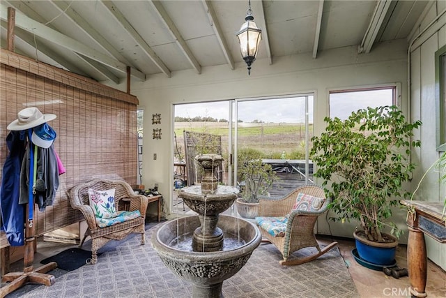 sunroom / solarium with vaulted ceiling with beams