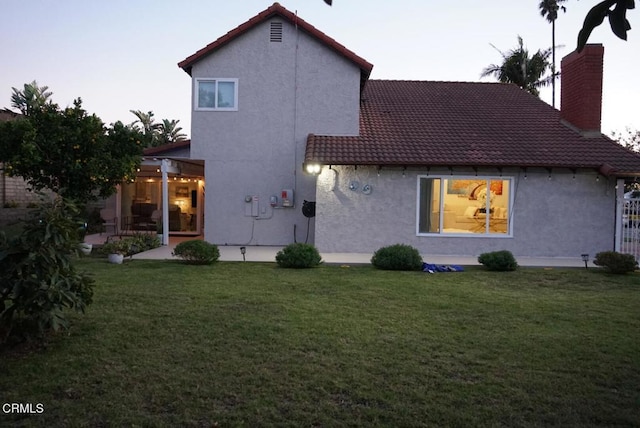 back of house featuring a yard