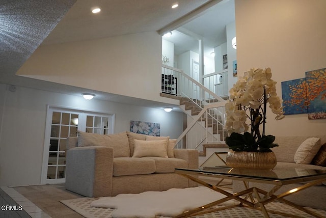 living room featuring high vaulted ceiling and beam ceiling