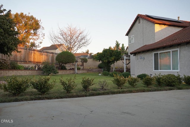 view of home's exterior featuring a yard and solar panels