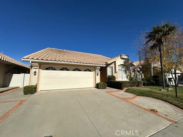 mediterranean / spanish-style home with a garage