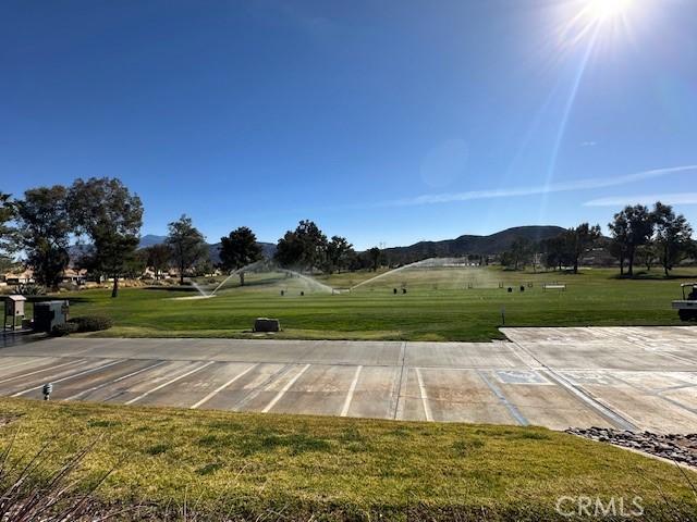 exterior space with a mountain view and a lawn