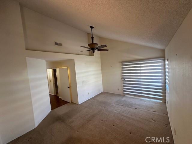 carpeted spare room with a textured ceiling, high vaulted ceiling, and ceiling fan