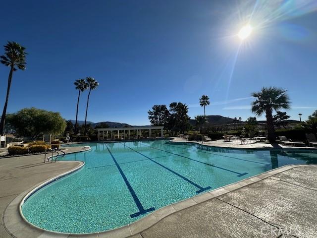 view of pool featuring a mountain view and a patio