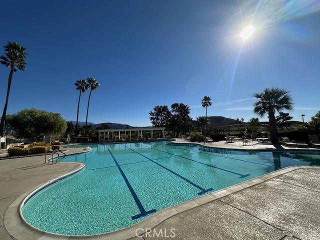 view of swimming pool with a mountain view and a patio area