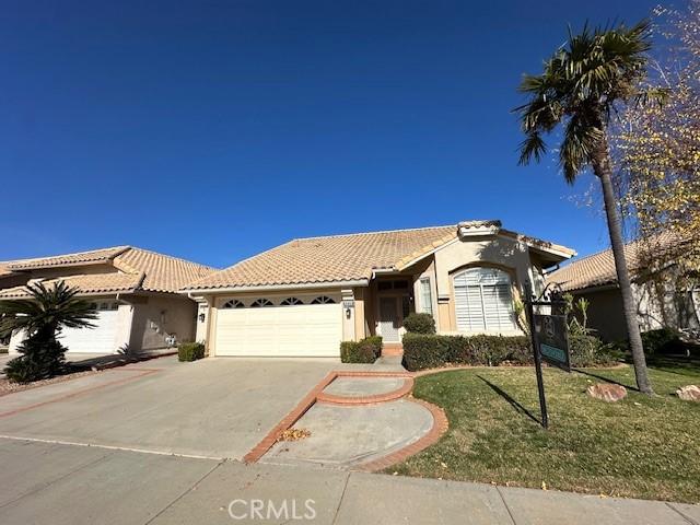 mediterranean / spanish house with a garage and a front yard