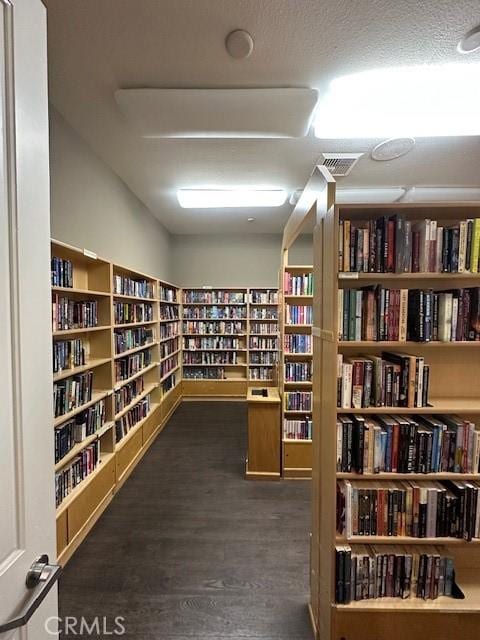 interior space with dark wood-type flooring and a textured ceiling