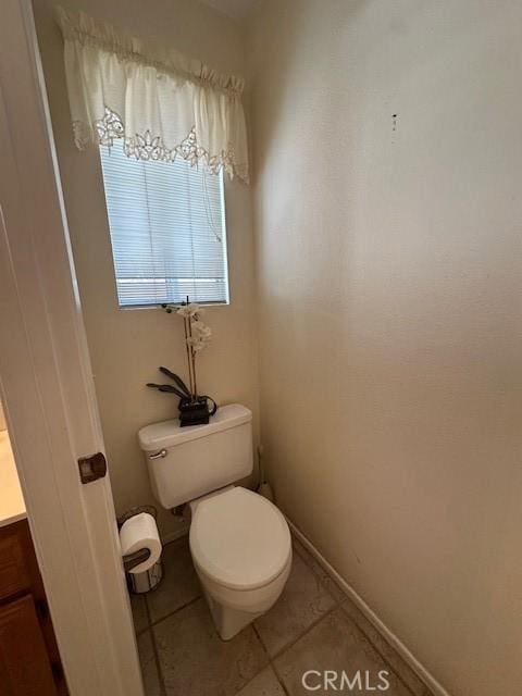 bathroom with tile patterned floors, vanity, and toilet