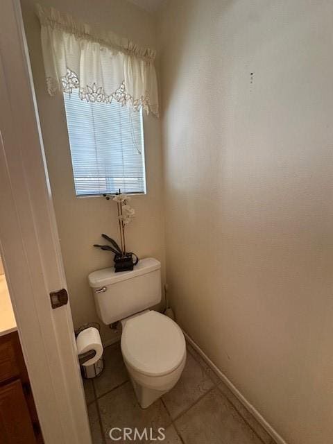 bathroom with tile patterned floors, toilet, and vanity