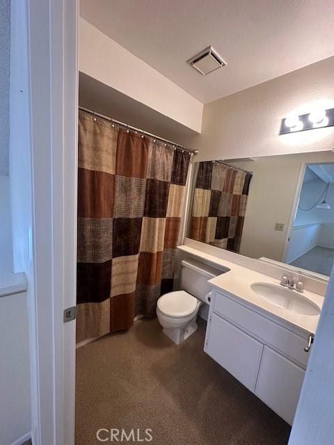 bathroom with vanity, walk in shower, and toilet