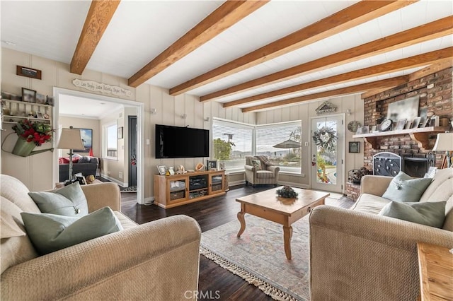 living room featuring dark hardwood / wood-style flooring, beamed ceiling, and a fireplace