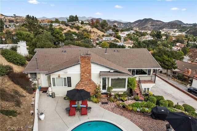 rear view of property with a patio area and a mountain view