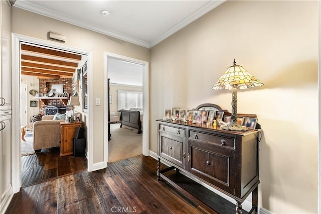 hallway featuring beam ceiling, dark wood-type flooring, and crown molding