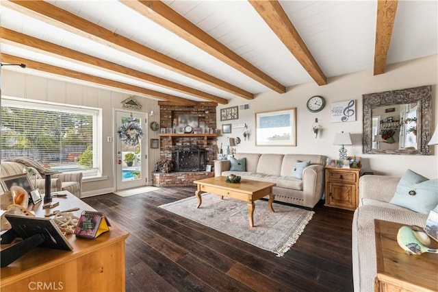 living room featuring dark wood-type flooring, beamed ceiling, and a fireplace