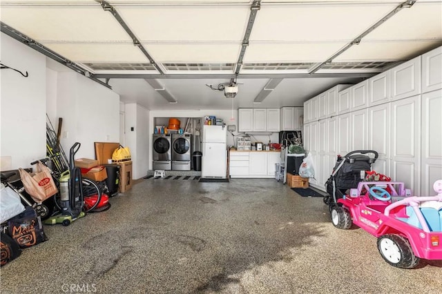 garage with a garage door opener, washer and dryer, and white refrigerator